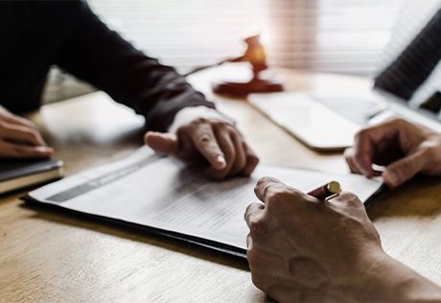 People signing paperwork